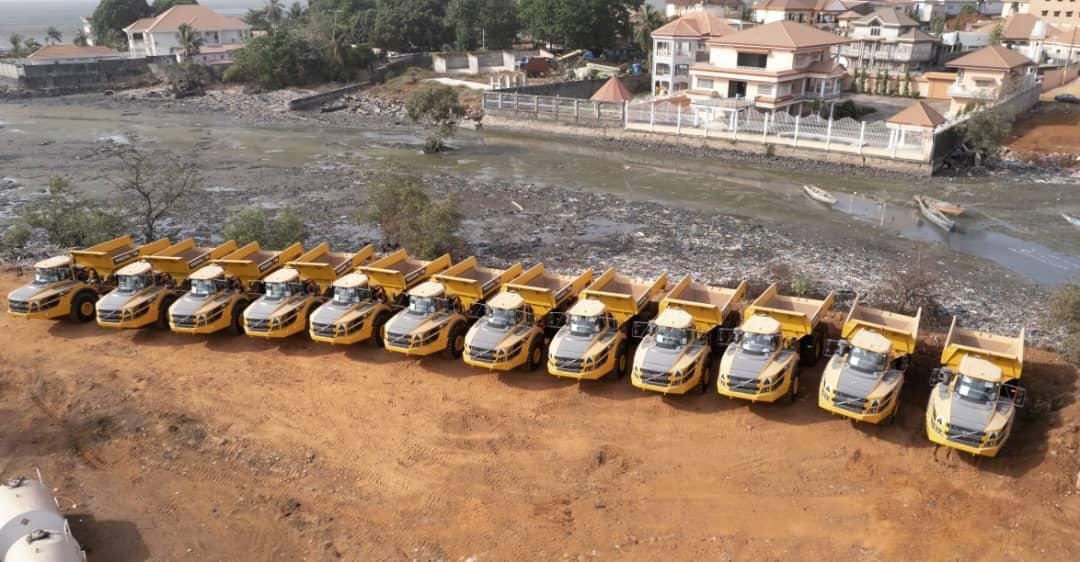 Flotte de tombereaux articulés alignés sur un chantier